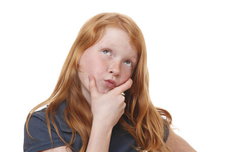 Portrait of a thinking young girl on white backgroundの写真素材
