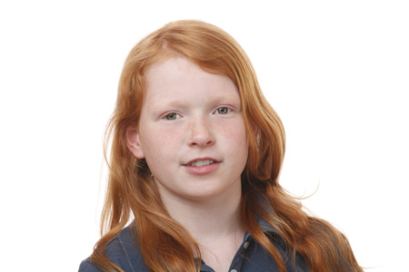 Portrait of a pretty red haired girl on white backgroundの写真素材