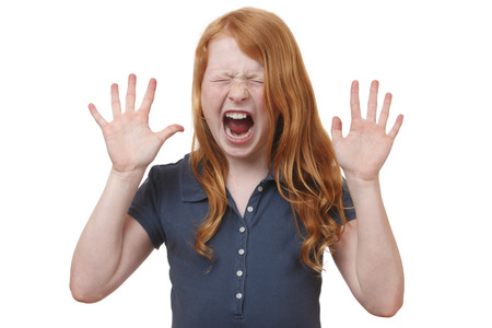 Portrait of a screaming young girl on white backgroundの写真素材