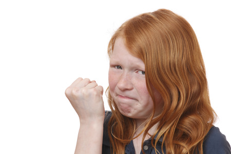 Portrait of an angry young girl on white backgroundの写真素材