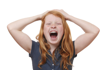 Portrait of a screaming young girl on white backgroundの写真素材