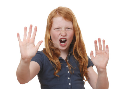 Portrait of a screaming young girl on white backgroundの写真素材