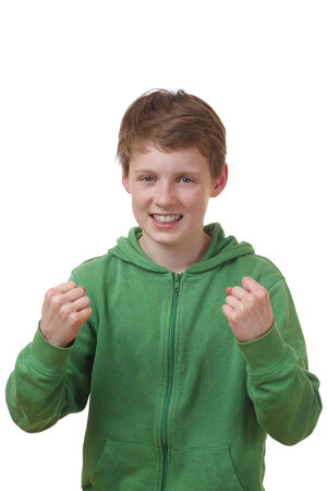 Portrait of a winning young boy on white backgroundの写真素材
