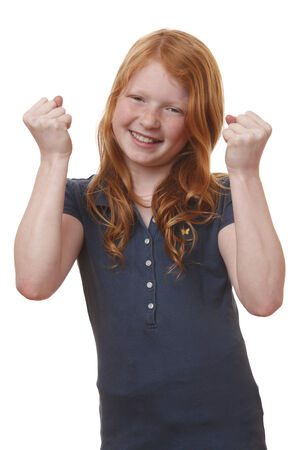 Portrait of a winning young girl on white backgroundの写真素材
