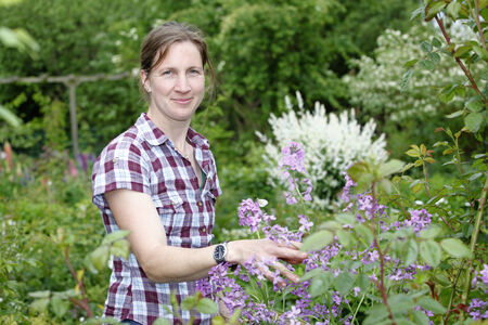 Young woman working outdoors in the gardenの写真素材
