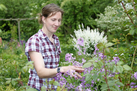Young woman working outdoors in the gardenの写真素材