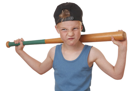 Portrait of a cool young boy with baseball bat on white backgroundの写真素材