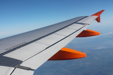 Wing of an airplane high in the skyの写真素材