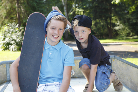 Cool young boys outdoor with skateboardの写真素材