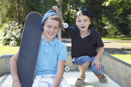 Cool young boys outdoor with skateboardの写真素材