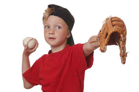 Young boy throws a baseball on white backgroundの写真素材