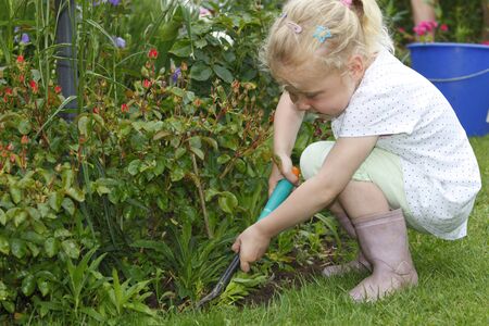 Young girl works outdoor in the gardenの写真素材