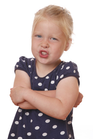 Portrait of an angry young girl on white backgroundの写真素材