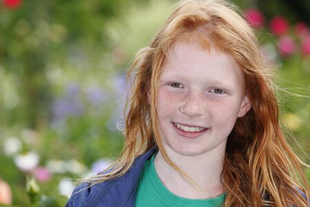 Portrait of a happy young girl outdoorsの写真素材