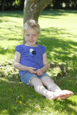 Portrait of a happy young girl outdoorsの写真素材