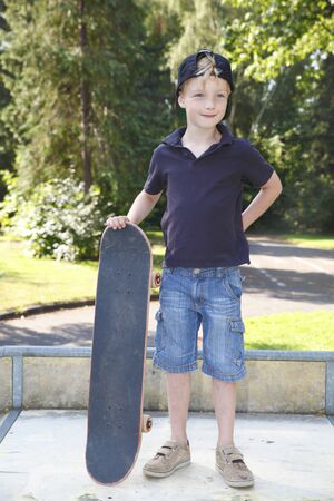 Cool young boy outdoor with skateboardの写真素材