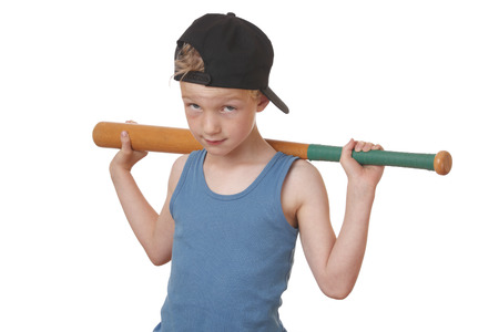Portrait of a cool young boy with baseball bat on white backgroundの写真素材