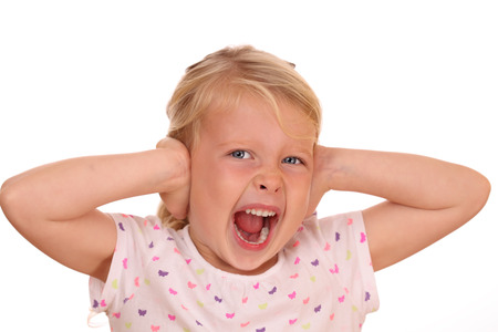 Portrait of a screaming young girl on white backgroundの写真素材