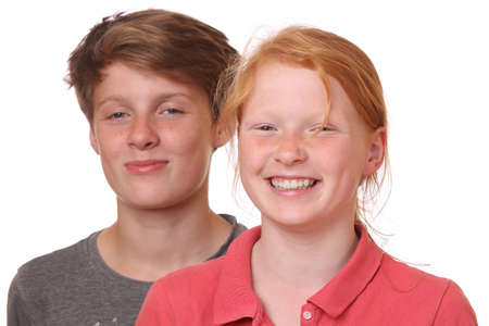 Portrait of two happy teenagers on white backgroundの写真素材