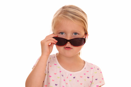 Portrait of a cool looking girl with sunglasses on white backgroundの写真素材