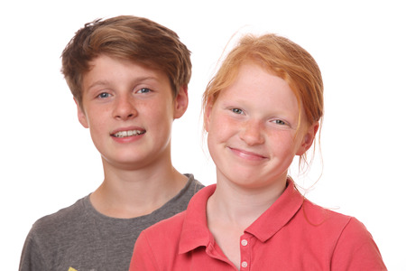 Portrait of two happy teenagers on white backgroundの写真素材