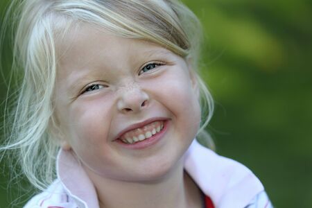 Portrait of a smiling young girl in the gardenの写真素材