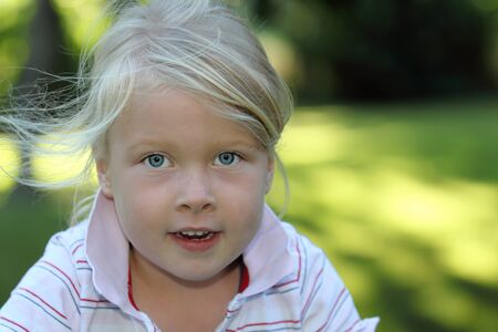 Portrait of a smiling young girl in the gardenの写真素材