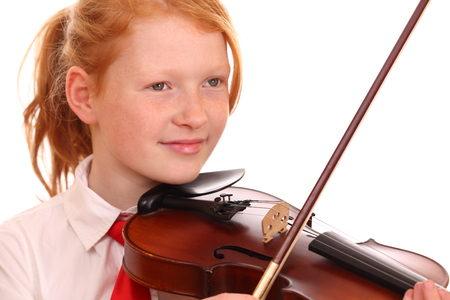 Portrait of a young girl playing violin on white backgroundの写真素材