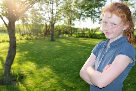 Portrait of a beautiful young girl outdoors in the garden
