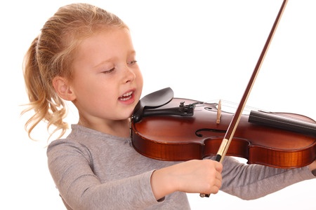 Portrait of a young girl playing violin on white backgroundの写真素材