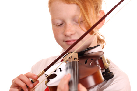 Portrait of a young girl playing violin on white backgroundの写真素材