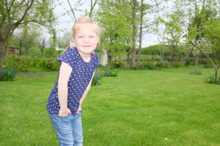 Portrait of a beautiful young girl outdoors in the gardenの写真素材