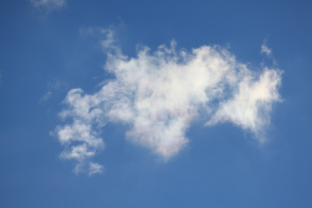 A fluffy white cloud on blue sky backgroundの写真素材