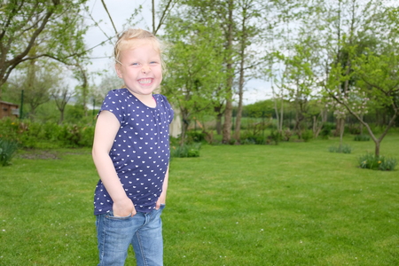 Portrait of a beautiful young girl outdoors in the gardenの写真素材