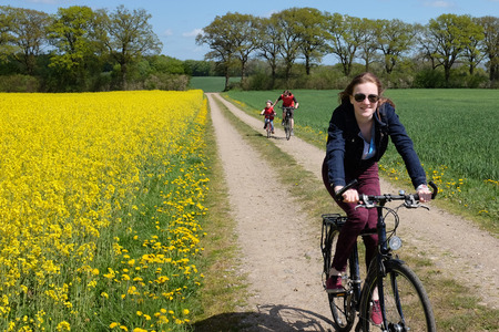 Happy young girl biking in the countrysideの写真素材