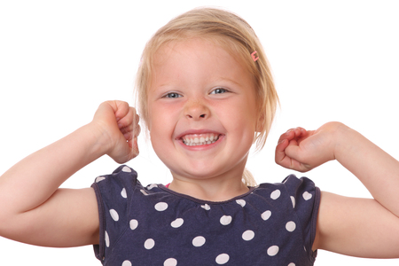Portrait of a happy young girl celebrating victory on white backgroundの写真素材
