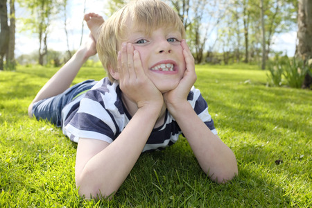 Portrait of a happy young boy in the gardenの写真素材