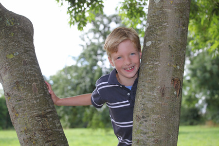 Portrait of a happy young boy outdoorsの写真素材