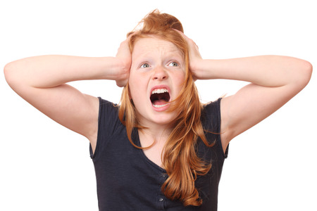 Portrait of a screaming young girl on white backgroundの写真素材