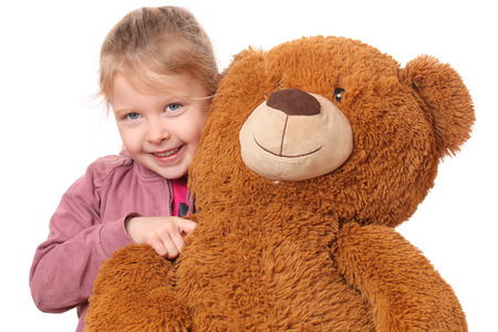 Portrait of a young girl with teddy bear on white backgroundの写真素材
