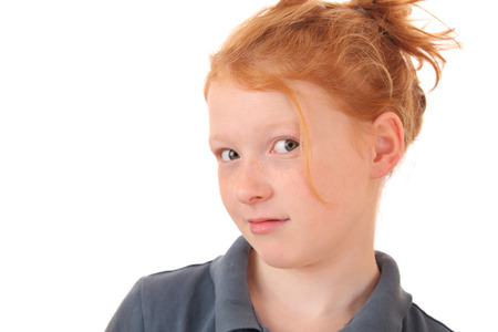 Portrait of a skeptical young teenage girl on white backgroundの写真素材