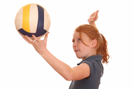 Portrait of a young girl with volleyball on white backgroundの写真素材