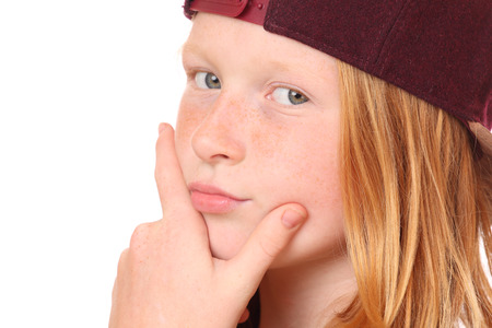 Portrait of a thinking young girl on white backgroundの写真素材