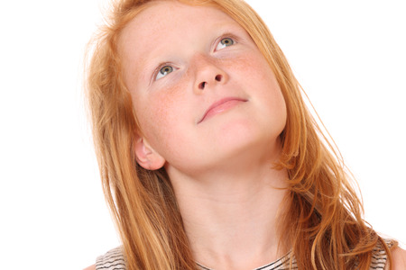 Portrait of a smiling young girl on white backgroundの写真素材