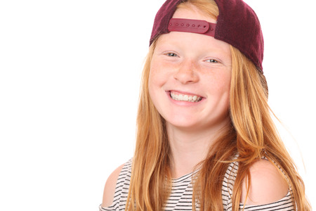 Portrait of a smiling young girl on white backgroundの写真素材