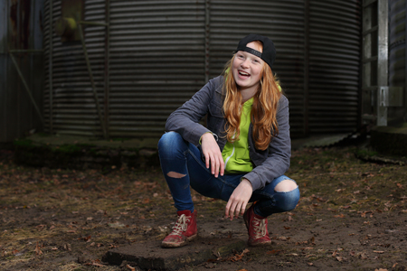Portrait of a cool teenage girl outdoors with baseball capの写真素材