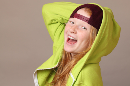 Portrait of a happy teenage girl on gray backgroundの写真素材