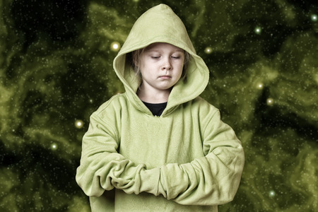 Portrait of a serious looking child girl on starfield backgroundの写真素材