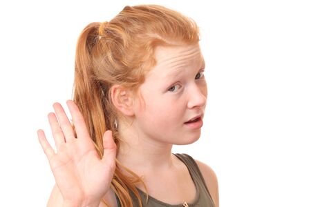 Portrait of a teenage girl showing stop gesture with hand on white backgroundの写真素材