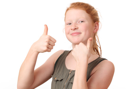 Portrait of a happy teenage girl showing thumbs up on white background